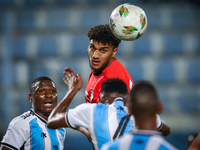 Osama Faisal of the Egypt team battles for possession with Thatayaone Ditlhokwe of the Botswana team during the Africa Cup of Nations Qualif...