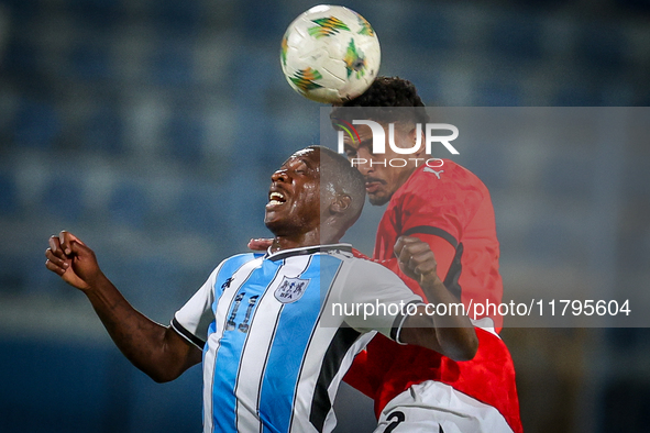 Hossam Abdelmaguid of the Egypt team battles for possession with Tumisang Orebonye of the Botswana team during the Africa Cup of Nations Qua...