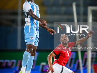 Mohamed Youssef of the Egypt team battles for possession with Tumisang Orebonye of the Botswana team during the Africa Cup of Nations Qualif...