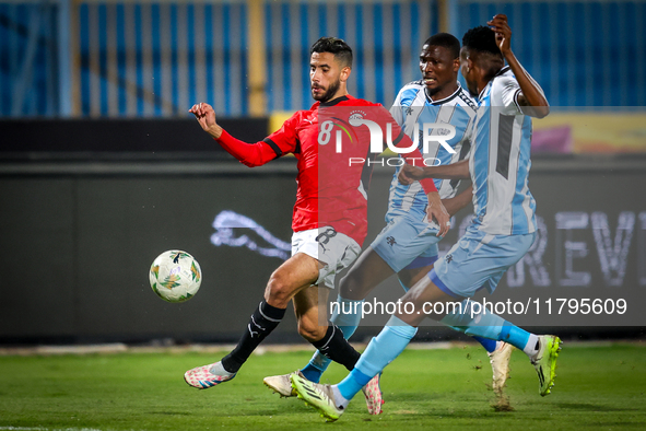 Nasser Maher of the Egypt team battles for possession with Thatayaone Ditlhokwe and Mosha Gaolaolwe of the Botswana team during the Africa C...