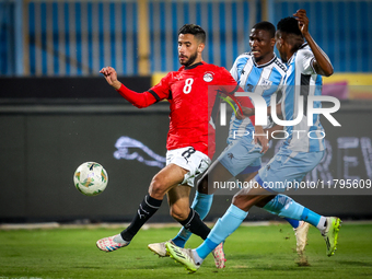 Nasser Maher of the Egypt team battles for possession with Thatayaone Ditlhokwe and Mosha Gaolaolwe of the Botswana team during the Africa C...