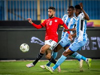 Nasser Maher of the Egypt team battles for possession with Thatayaone Ditlhokwe and Mosha Gaolaolwe of the Botswana team during the Africa C...