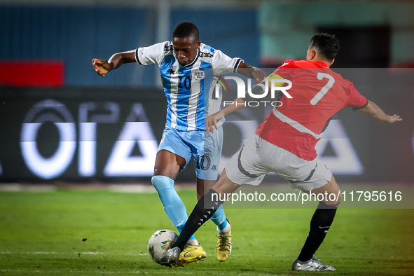 Mahmoud Trezeguet of the Egypt team battles for possession with Thabang Sesinyi of the Botswana team during the Africa Cup of Nations Qualif...