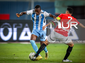 Mahmoud Trezeguet of the Egypt team battles for possession with Thabang Sesinyi of the Botswana team during the Africa Cup of Nations Qualif...