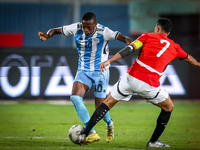 Mahmoud Trezeguet of the Egypt team battles for possession with Thabang Sesinyi of the Botswana team during the Africa Cup of Nations Qualif...