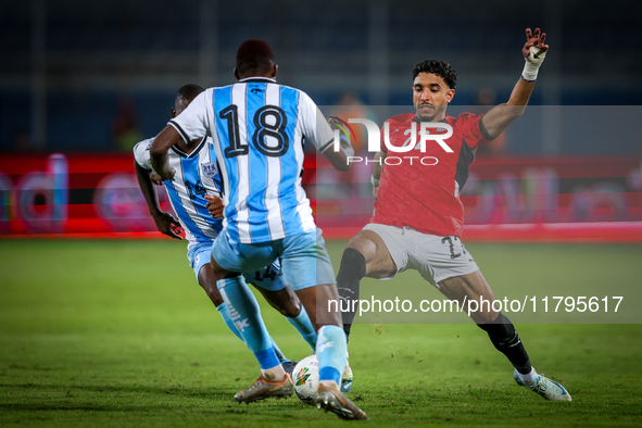 Omar Marmoush of the Egypt team battles for possession with Godiraone Modingwane and Lebogang Ditsele of the Botswana team during the Africa...