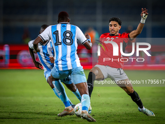 Omar Marmoush of the Egypt team battles for possession with Godiraone Modingwane and Lebogang Ditsele of the Botswana team during the Africa...