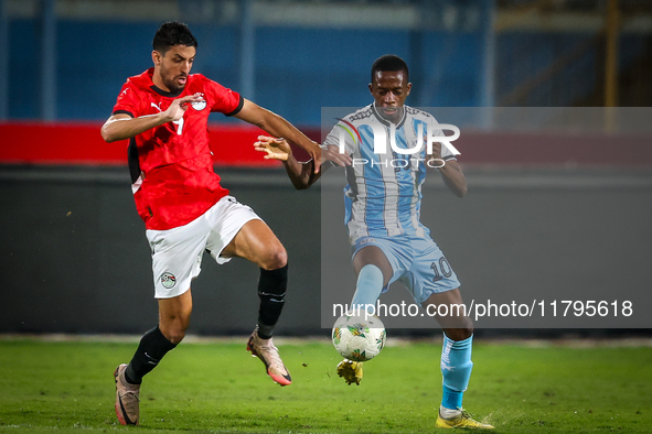 Taher Mohamed of the Egypt team battles for possession with Thabang Sesinyi of the Botswana team during the Africa Cup of Nations Qualifiers...