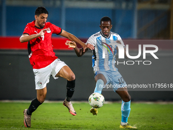 Taher Mohamed of the Egypt team battles for possession with Thabang Sesinyi of the Botswana team during the Africa Cup of Nations Qualifiers...