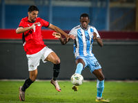 Taher Mohamed of the Egypt team battles for possession with Thabang Sesinyi of the Botswana team during the Africa Cup of Nations Qualifiers...