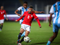 Nasser Maher of the Egypt team battles for possession with Omaatla Kebatho of the Botswana team during the Africa Cup of Nations Qualifiers...