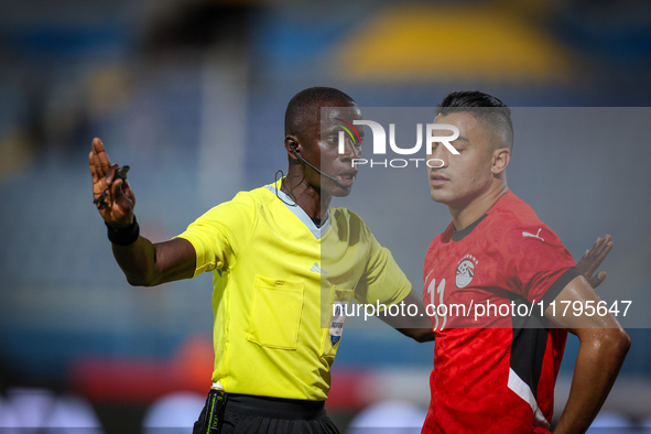 Referee Abdallah Jammeh talks to Mostafa Mohamed of the Egypt team during the Africa Cup of Nations Qualifiers match between Egypt and Botsw...