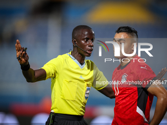 Referee Abdallah Jammeh talks to Mostafa Mohamed of the Egypt team during the Africa Cup of Nations Qualifiers match between Egypt and Botsw...