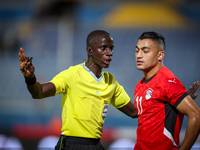 Referee Abdallah Jammeh talks to Mostafa Mohamed of the Egypt team during the Africa Cup of Nations Qualifiers match between Egypt and Botsw...