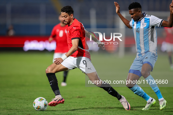 Taher Mohamed of the Egypt team battles for possession with Mosha Gaolaolwe of the Botswana team during the Africa Cup of Nations Qualifiers...