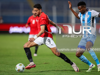 Taher Mohamed of the Egypt team battles for possession with Mosha Gaolaolwe of the Botswana team during the Africa Cup of Nations Qualifiers...