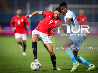 Taher Mohamed of the Egypt team battles for possession with Mosha Gaolaolwe of the Botswana team during the Africa Cup of Nations Qualifiers...