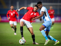 Taher Mohamed of the Egypt team battles for possession with Mosha Gaolaolwe of the Botswana team during the Africa Cup of Nations Qualifiers...