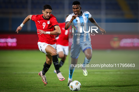 Taher Mohamed of the Egypt team battles for possession with Mosha Gaolaolwe of the Botswana team during the Africa Cup of Nations Qualifiers...