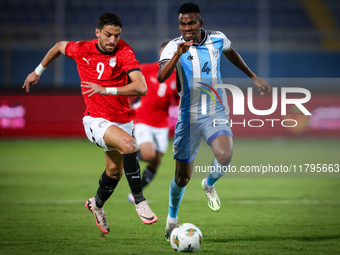 Taher Mohamed of the Egypt team battles for possession with Mosha Gaolaolwe of the Botswana team during the Africa Cup of Nations Qualifiers...