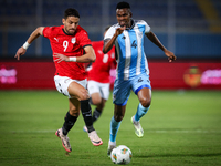 Taher Mohamed of the Egypt team battles for possession with Mosha Gaolaolwe of the Botswana team during the Africa Cup of Nations Qualifiers...