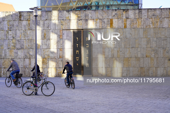 This image captures a moment at the Ohel Jakob Synagogue on St. Jakob's Square in Munich, Germany, on January 7, 2023. The warm limestone ti...