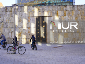 This image captures a moment at the Ohel Jakob Synagogue on St. Jakob's Square in Munich, Germany, on January 7, 2023. The warm limestone ti...