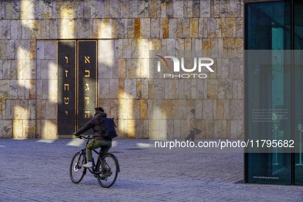 A cyclist and a pedestrian move across St. Jakob's Square in Munich, Germany, on January 7, 2023, near the portal of the Ohel Jakob synagogu...