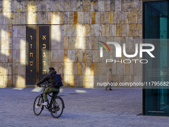 A cyclist and a pedestrian move across St. Jakob's Square in Munich, Germany, on January 7, 2023, near the portal of the Ohel Jakob synagogu...