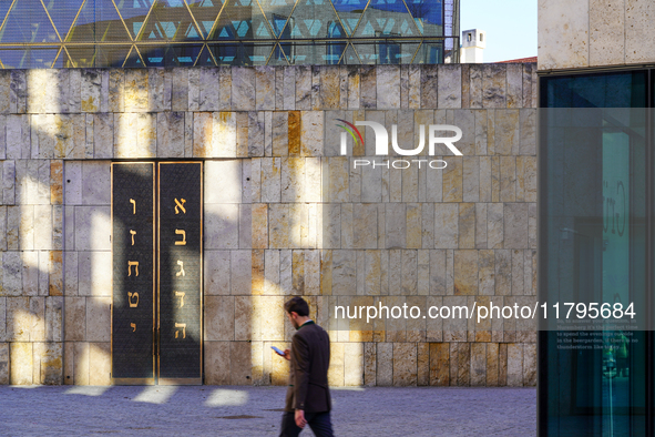 A man walks across St. Jakob's Square in Munich, Germany, on January 7, 2023, adjacent to the portal of the Ohel Jakob synagogue. The limest...