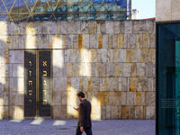 A man walks across St. Jakob's Square in Munich, Germany, on January 7, 2023, adjacent to the portal of the Ohel Jakob synagogue. The limest...