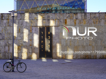 A bicycle parks near the entrance of the Ohel Jakob synagogue on St. Jakob's Square in Munich, Germany, on January 7, 2023. The sunlight cre...