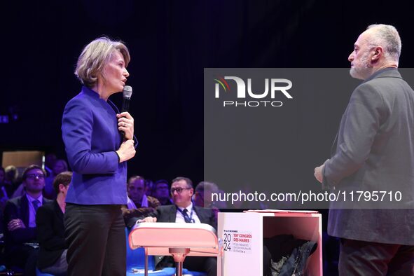 France's Minister of Education Anne Genetet (L) delivers a speech during the 106th session of the Congress of Mayors organized by the ''Fran...