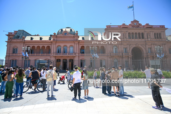 Followers of the Italian Prime Minister Giorgia Meloni wait for her to come out to greet them from the presidential balcony with the Argenti...