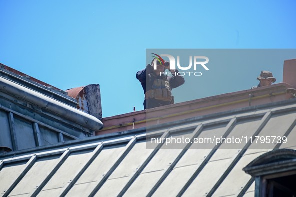 Security officers guard from the roof during the arrival of Italian Prime Minister Giorgia Meloni at La Casa Rosada in Buenos Aires, Argenti...