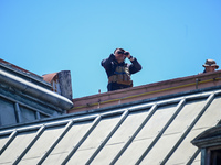 Security officers guard from the roof during the arrival of Italian Prime Minister Giorgia Meloni at La Casa Rosada in Buenos Aires, Argenti...