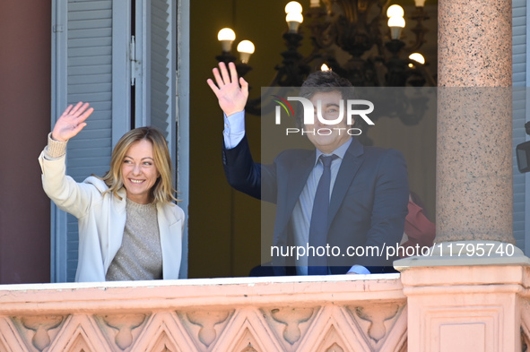 Italian Prime Minister Giorgia Meloni and Argentinian President Javier Milei greet from the balcony of the Argentine Government House in Bue...