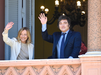 Italian Prime Minister Giorgia Meloni and Argentinian President Javier Milei greet from the balcony of the Argentine Government House in Bue...