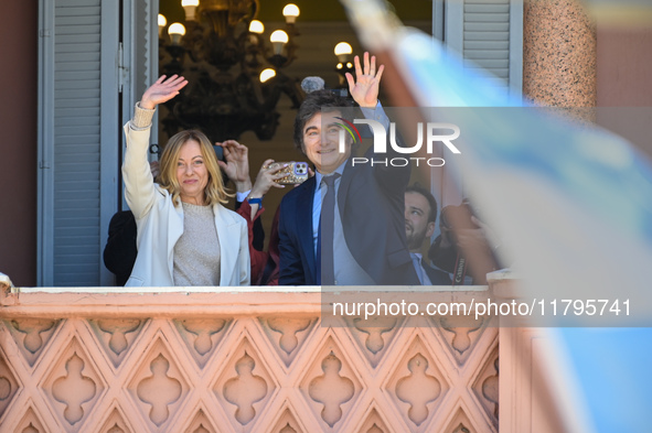 Italian Prime Minister Giorgia Meloni and Argentinian President Javier Milei greet from the balcony of the Argentine Government House in Bue...