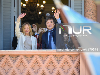 Italian Prime Minister Giorgia Meloni and Argentinian President Javier Milei greet from the balcony of the Argentine Government House in Bue...