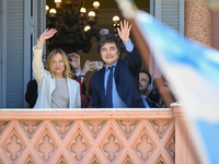 Italian Prime Minister Giorgia Meloni and Argentinian President Javier Milei greet from the balcony of the Argentine Government House in Bue...