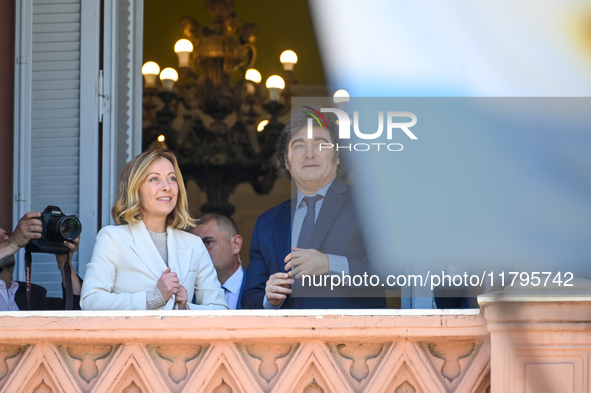 Italian Prime Minister Giorgia Meloni and Argentinian President Javier Milei greet from the balcony of the Argentine Government House in Bue...