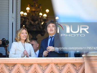 Italian Prime Minister Giorgia Meloni and Argentinian President Javier Milei greet from the balcony of the Argentine Government House in Bue...