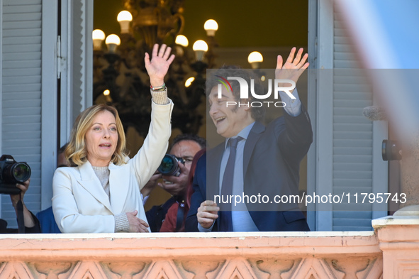 Italian Prime Minister Giorgia Meloni and Argentinian President Javier Milei greet from the balcony of the Argentine Government House in Bue...