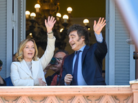 Italian Prime Minister Giorgia Meloni and Argentinian President Javier Milei greet from the balcony of the Argentine Government House in Bue...