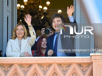 Italian Prime Minister Giorgia Meloni and Argentinian President Javier Milei greet from the balcony of the Argentine Government House in Bue...