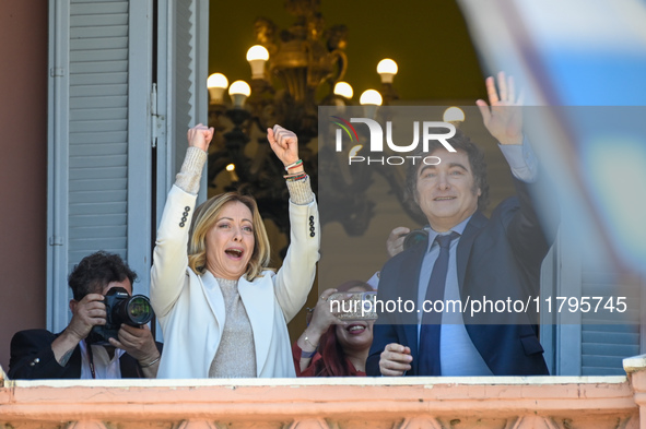 Italian Prime Minister Giorgia Meloni and Argentinian President Javier Milei greet from the balcony of the Argentine Government House in Bue...