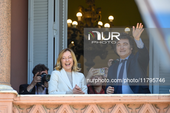 Italian Prime Minister Giorgia Meloni and Argentinian President Javier Milei greet from the balcony of the Argentine Government House in Bue...