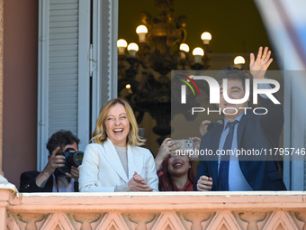 Italian Prime Minister Giorgia Meloni and Argentinian President Javier Milei greet from the balcony of the Argentine Government House in Bue...