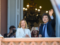 Italian Prime Minister Giorgia Meloni and Argentinian President Javier Milei greet from the balcony of the Argentine Government House in Bue...